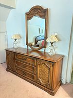 Front view of Broyhill dresser with matching mirror and lamps on top