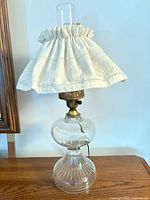 Full view of first lamp showing glass base, chimney and linen shade