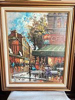 Full view of framed oil painting showing Parisian café scene and frame details