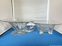 Scalloped pedestal glass bowl and etched footed glass bowl side by side