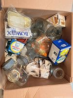 Box containing assorted Mason jars, metal lids, bands, lid packages, pectin box, wax pack