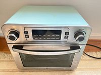 Front view showing control panel, knobs, door