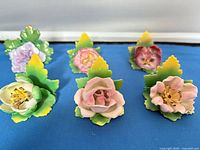 Six porcelain floral place card holders front view