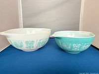 White and turquoise Pyrex Butterprint bowls side by side