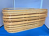 stack of ten identical bamboo trays, side view shows slat rims