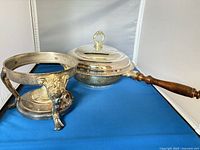 Stand and pan with lid and handle displayed