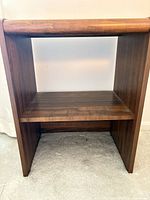 Frontal view of wood bookshelf with one shelf