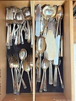 Drawer view of mixed silverplate forks and spoons