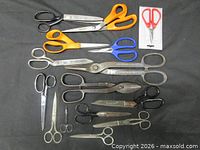 Group shot of all scissors, shears and snips arranged on surface