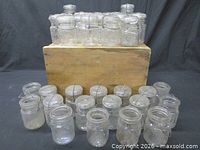 Group of clear glass Ball Ideal pint jars arranged on and in front of wooden crate
