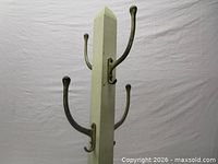 Upper section showing square post, pyramidal cap, and metal hooks