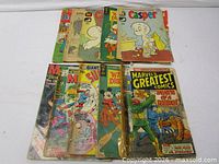 Group shot of all nine comics showing covers and general wear