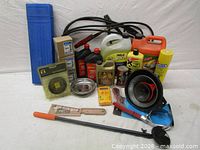 Group shot of all automotive fluids, jumper cables, tools and accessories