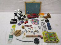 Full lot layout showing R/C buggy, controller, diecast cars, wooden toys, chalkboard, McDonald’s items and assorted small parts