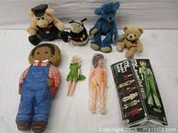 Group shot showing all dolls, plush toys and kit