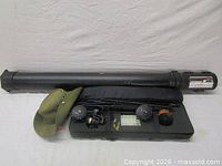 Lot overview showing Plano tube, hat, rod sections in bag, reels, tackle case