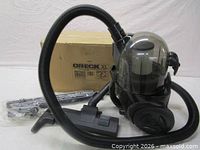 Vacuum, hose, floor head, wands, box visible