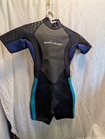 Front view of Body Glove shortie wetsuit hanging on hanger