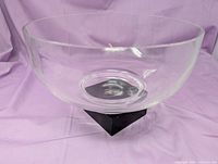 Side view of clear Tiffany crystal bowl on purple backdrop