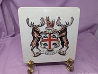 Front view showing embossed multicolour Hudson's Bay Company crest on white lid