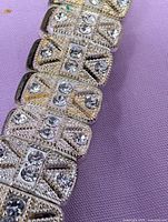 Close-up of rhinestone panel bracelet showing Art Deco motif, milgrain texture and clear stones