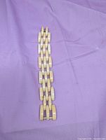 Full view of bone link bracelet on purple cloth background