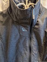 Close-up of collar, zip, Bench logo