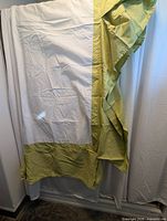 Folded queen bed skirt showing apple green drop and white center cloth