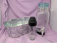 Galvanized tub, glass dispenser, cocktail shaker grouped