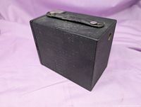 Rear angled view showing strap and textured body