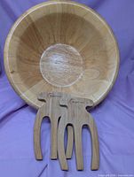 Wooden salad bowl with two Earth Chef bear claw servers displayed inside