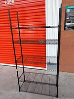 Full view of black metal wire shelving unit with five shelves