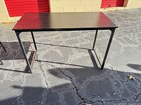 Overall view of black computer desk outdoors