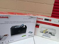 Boxed Canon Pixma TR4520 and Pixma MG2522 printers side by side