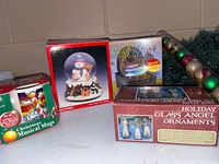 Group shot of four boxed Christmas items on table