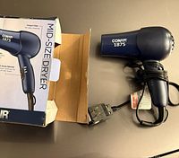 Hair dryer beside open original box