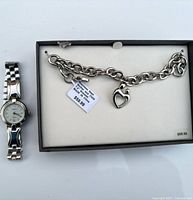 Watch, bracelet with charm, and box layout
