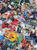 Pile of assorted action figures and vehicles