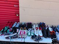 Full view of first section of table showing approximately half of the sneaker pairs