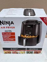 Sealed box front showing Ninja Air Fryer image and specs