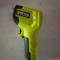 Left side view of Ryobi infrared thermometer showing brand logo