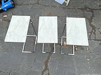 Top view of all three tables showing faux marble surfaces and chrome bases