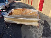 Full view of wrapped wood and cane sofa