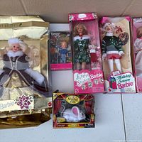 Group shot showing all boxed dolls and accessory set