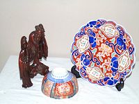 Overall lot: plate on stand, bowl inverted, two wood figures