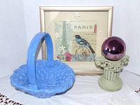 All three items together: blue ceramic basket, purple gazing ball on pedestal, framed Paris bird print