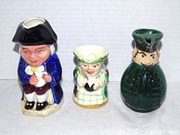 Front view of all three figural toby jugs