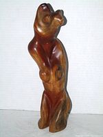 Front view of two-tone wood female torso sculpture