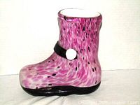 Left side view of pink and black spatter glass boot vase