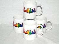 Five M Wares white mugs with rainbow dog design, grouped for overall view